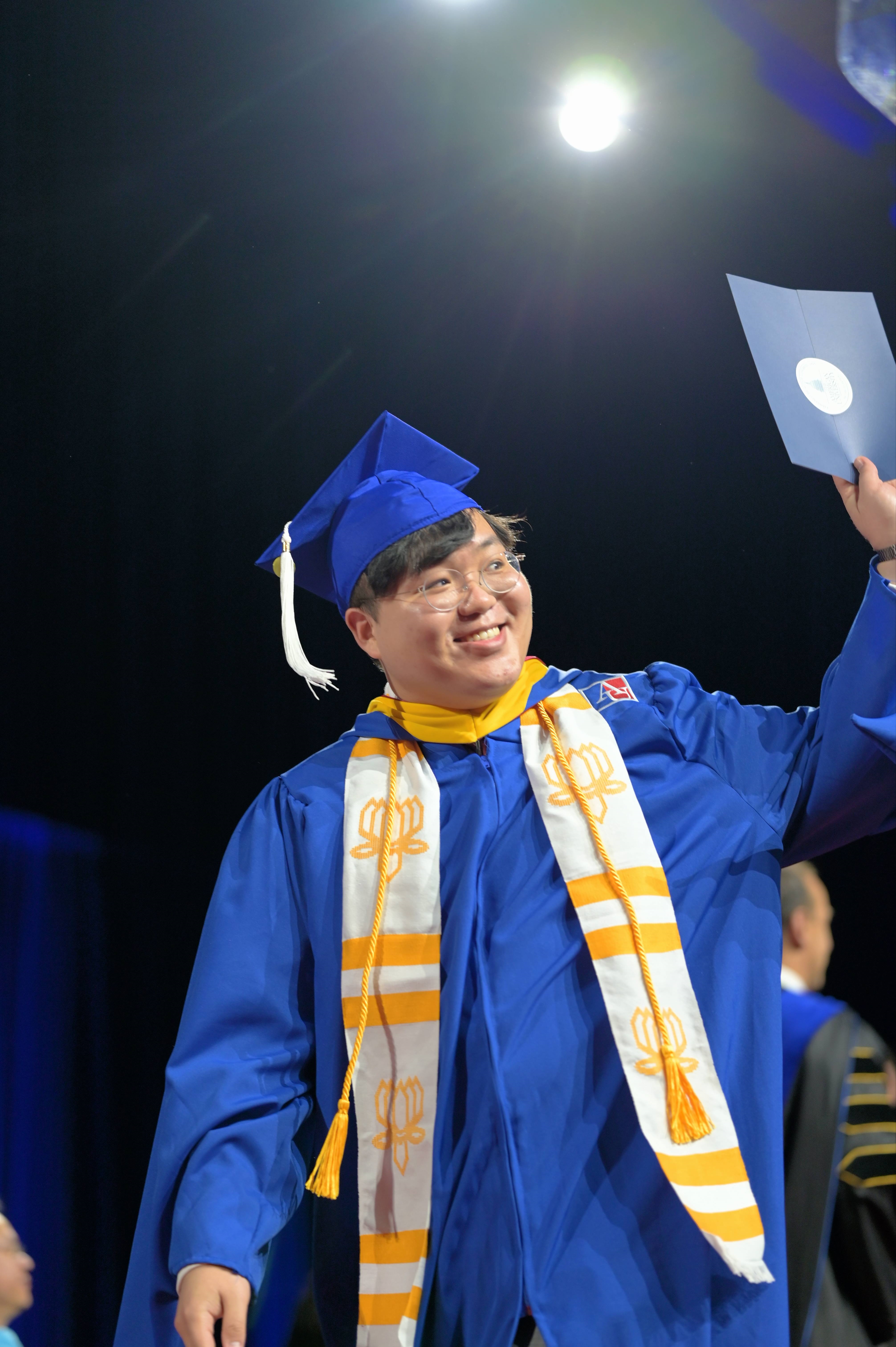 Crossing the stage at Commencement, Kogod School of Business